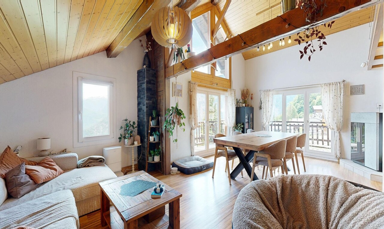 living area featuring light wood-style flooring and a high wood beamed ceiling