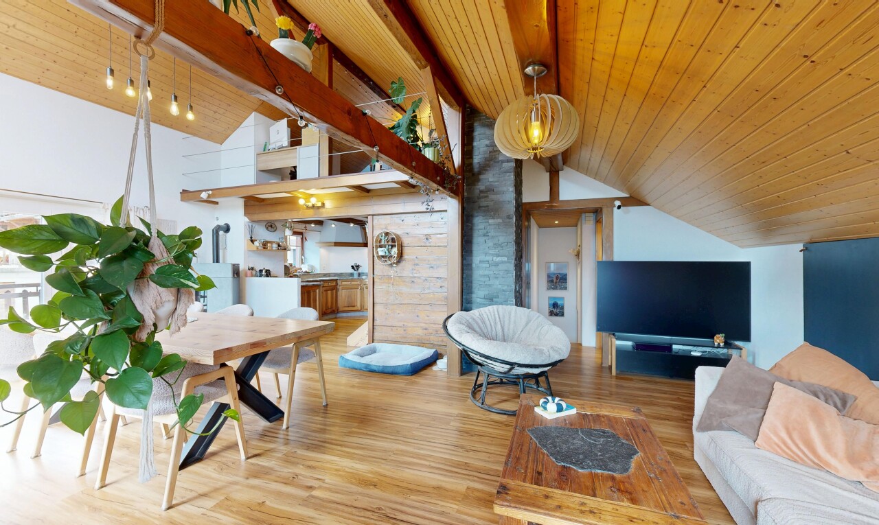 living room featuring a high wood beamed ceiling and wood finished floors