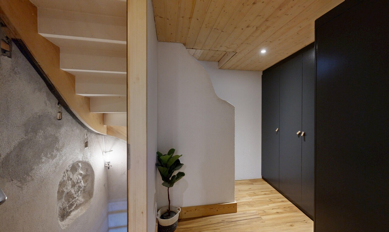 hallway with light wood finished floors, recessed lighting, and wooden ceiling