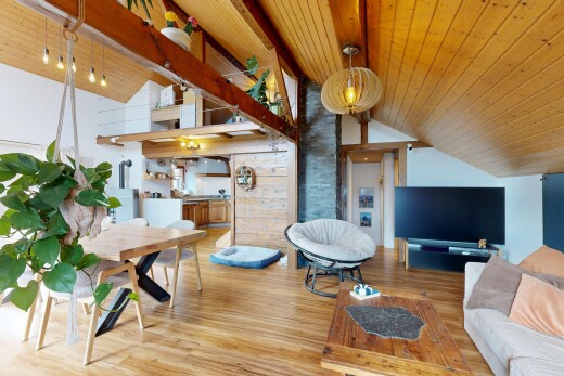 living room featuring a high wood beamed ceiling and wood finished floors
