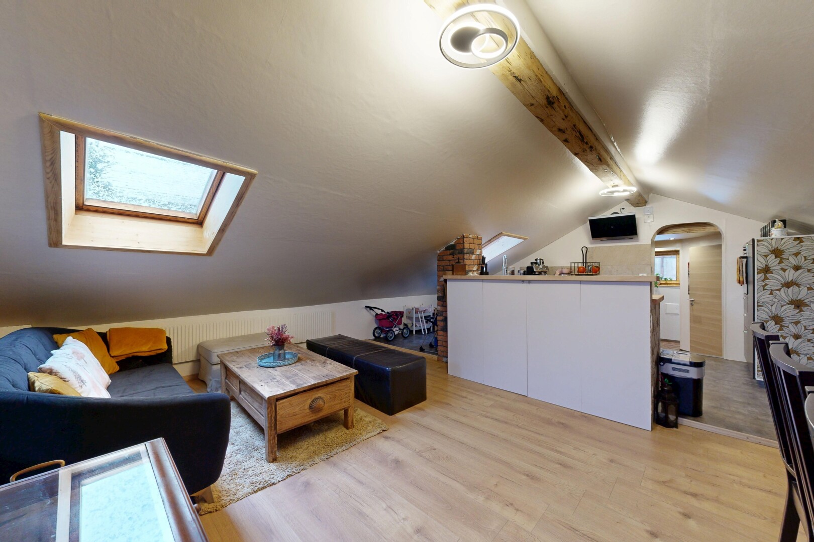 living area with light wood-style flooring and a skylight