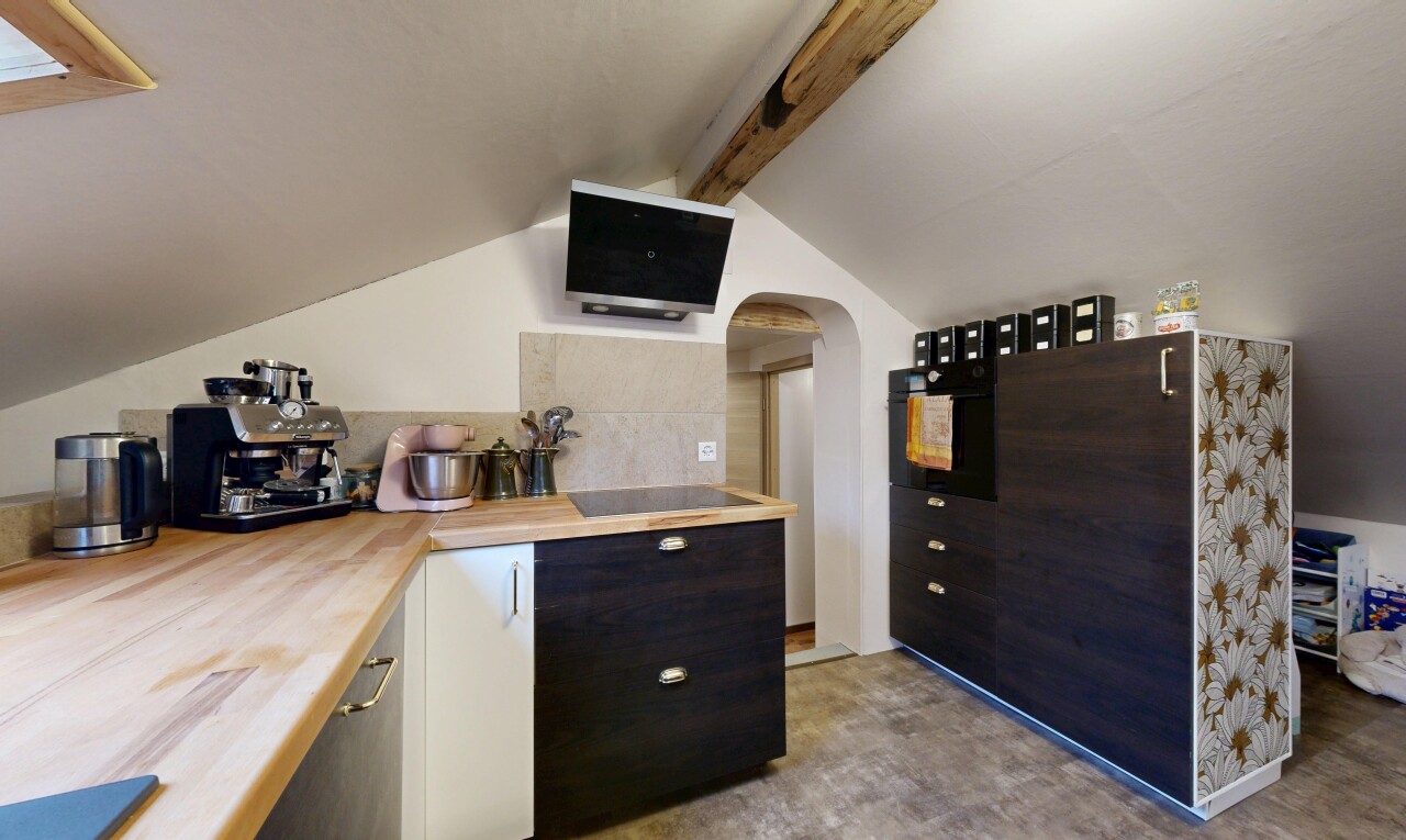 kitchen with arched walkways, black appliances, and butcher block counters