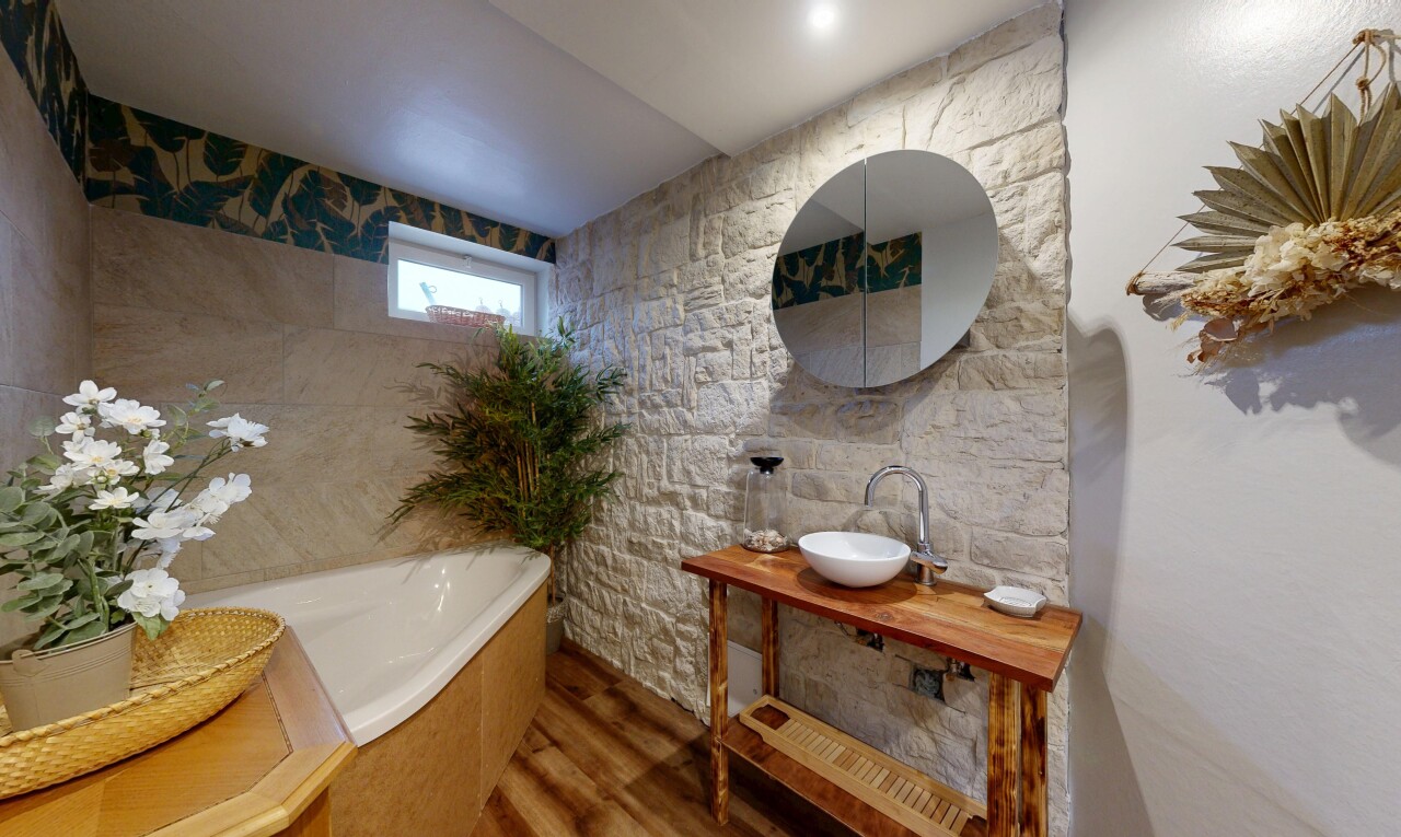 full bath featuring a bath, vanity, and wood finished floors