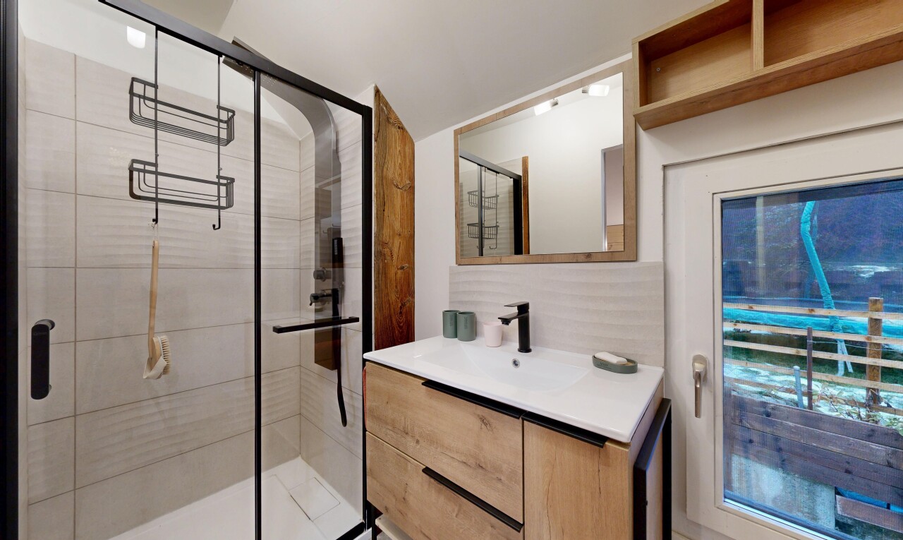 bathroom featuring vanity and a shower stall