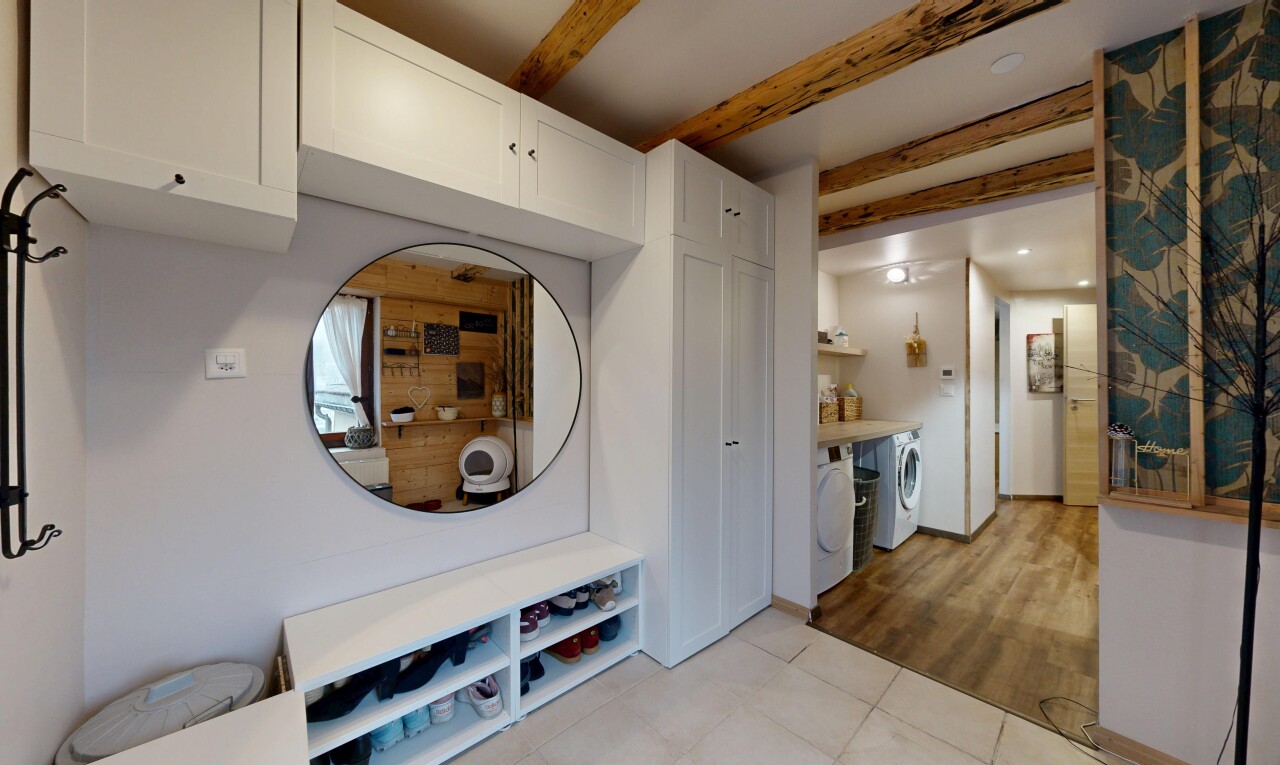 interior space featuring beamed ceiling, light tile patterned floors, and independent washer and dryer