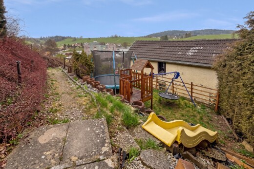 garden with a trampoline and a rural view