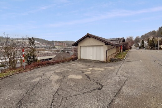 outdoor house with a garage and asphalt driveway