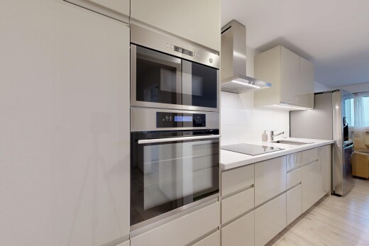 cuisine avec hotte, four double, light floor, light countertops, et plans de travail