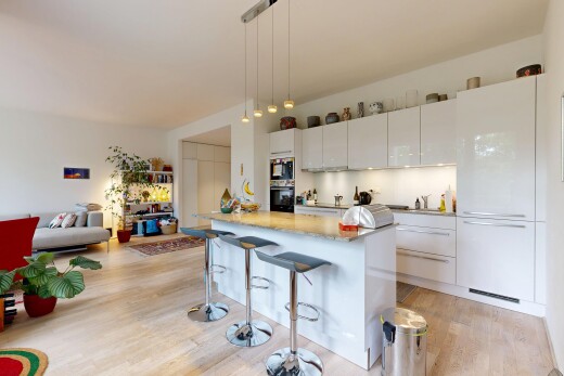 kitchen with a center island, white cabinets, black oven, and a breakfast bar