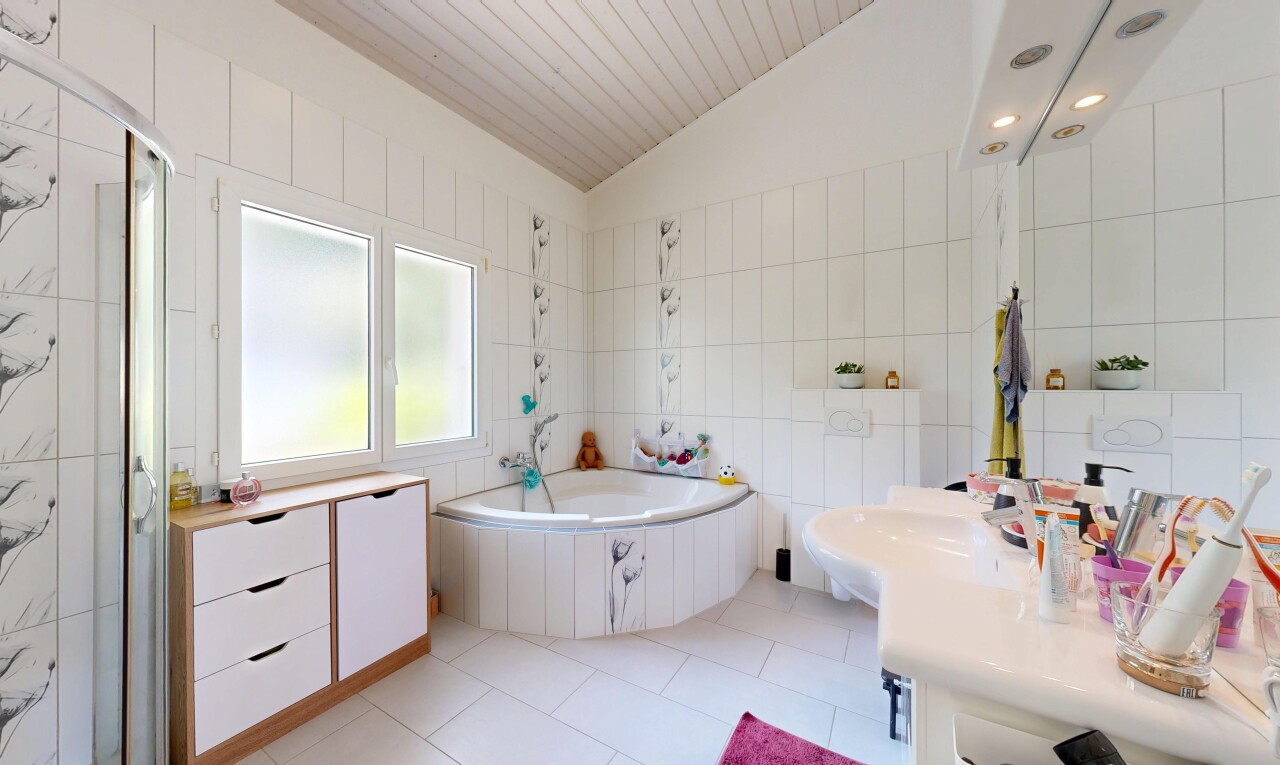salle de bains avec mur en carrelage, tile wall, salle de bain complète, light floor, et bain