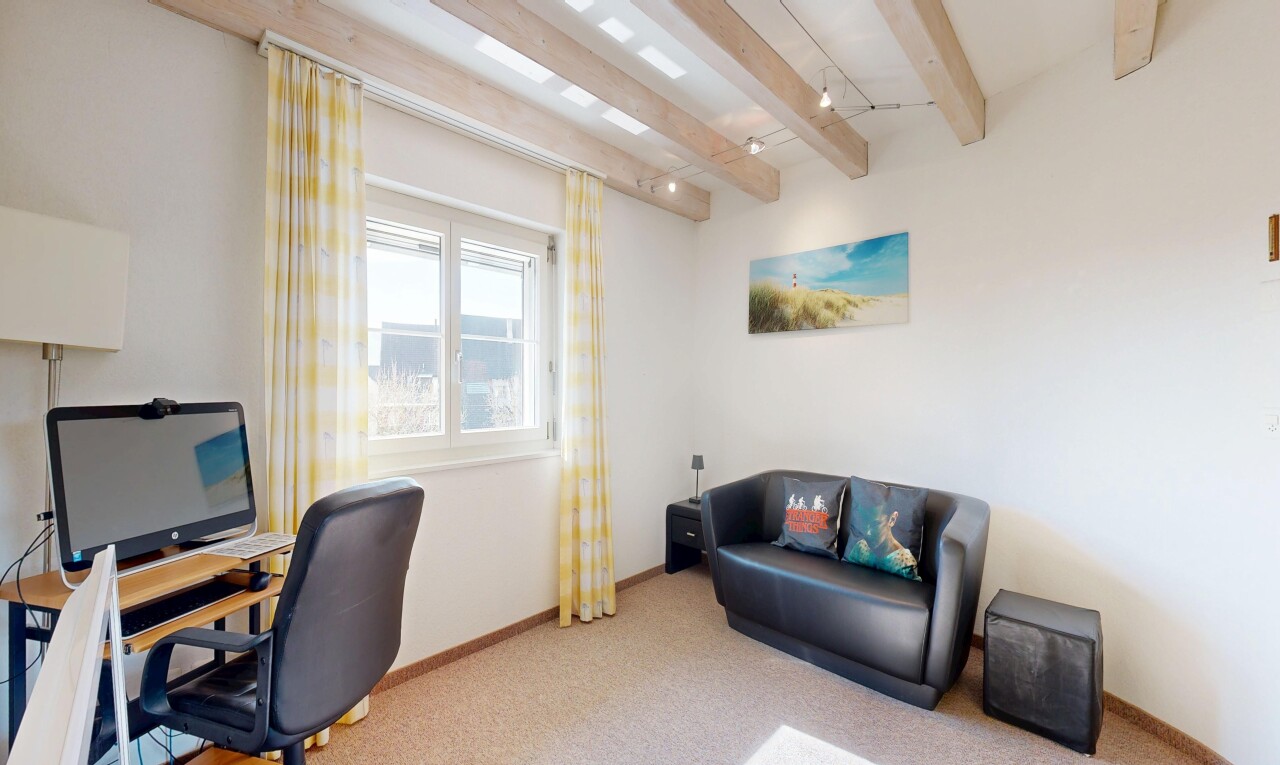 bureau avec télévision, moquette, carpet, espace bureau, et plafond à poutres