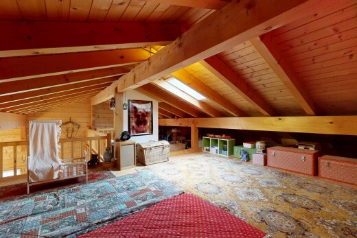 living area featuring wood ceiling, lofted ceiling with beams, and wooden walls