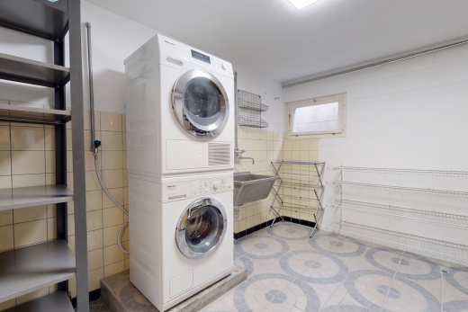 buanderie avec lave-linge et sèche-linge superposés, light floor, évier, buanderie, et inside property