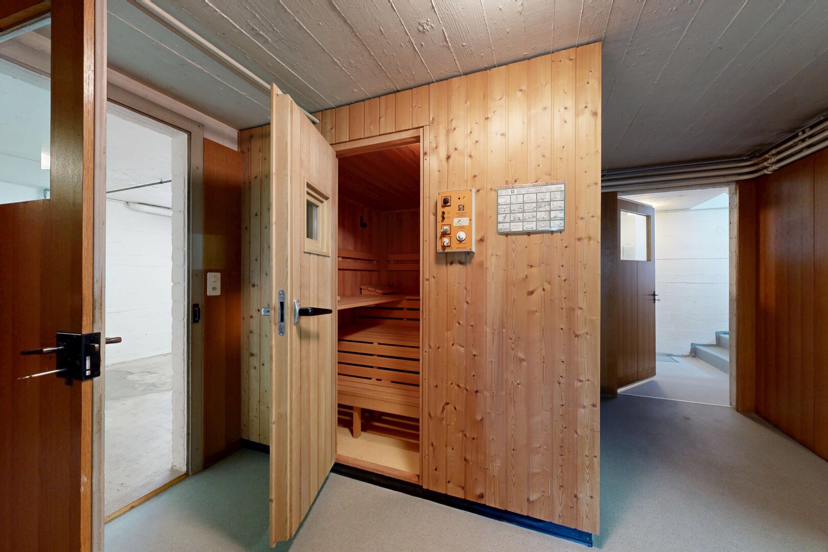 hallway with wood walls and a relaxing sauna