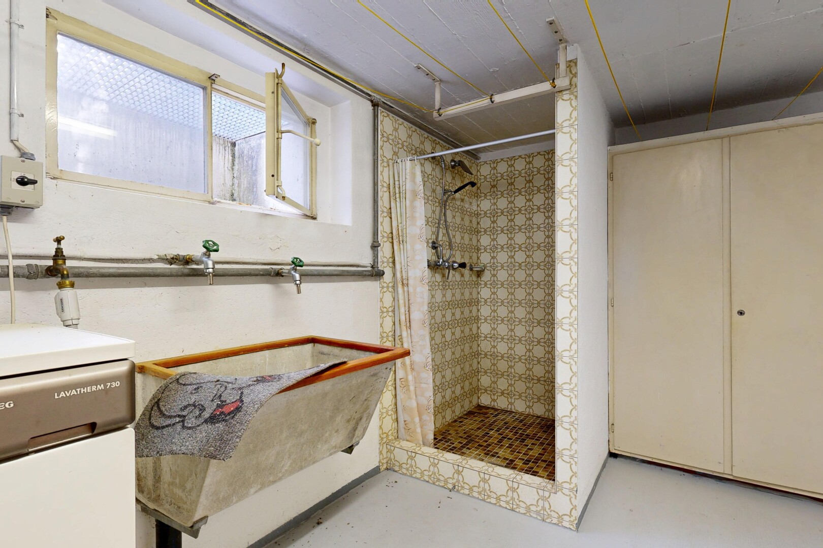full bath featuring a shower stall and concrete floors