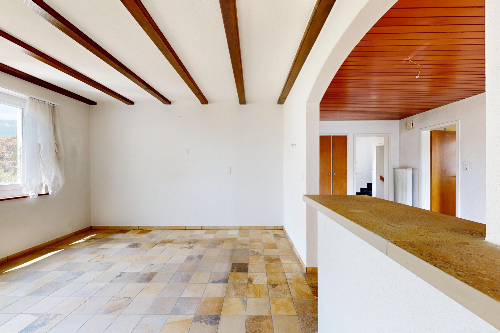 unfurnished room with beamed ceiling and baseboards