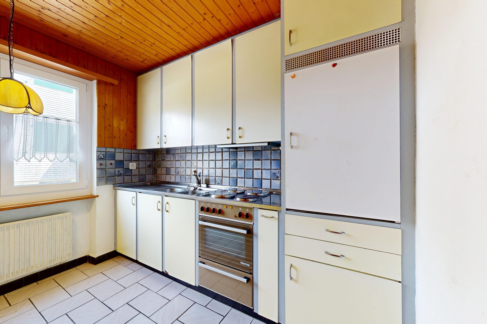 kitchen featuring backsplash, radiator heating unit, a warming drawer, wooden ceiling, and dark countertops