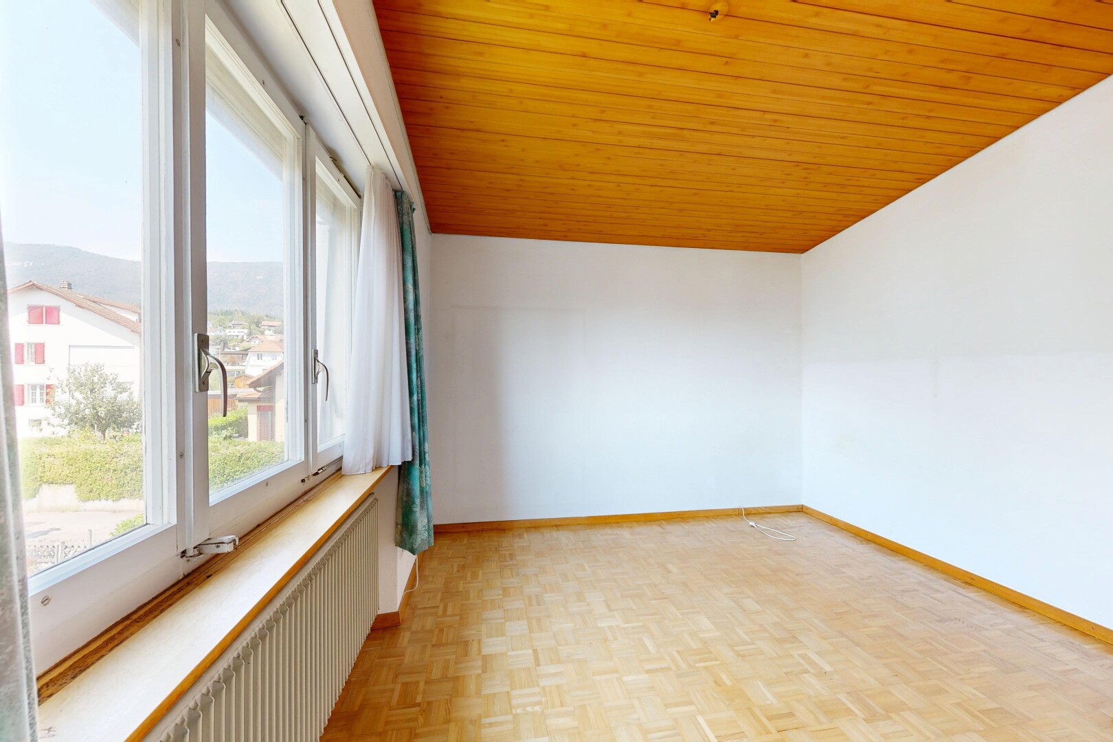 spare room featuring wooden ceiling, parquet flooring, and radiator