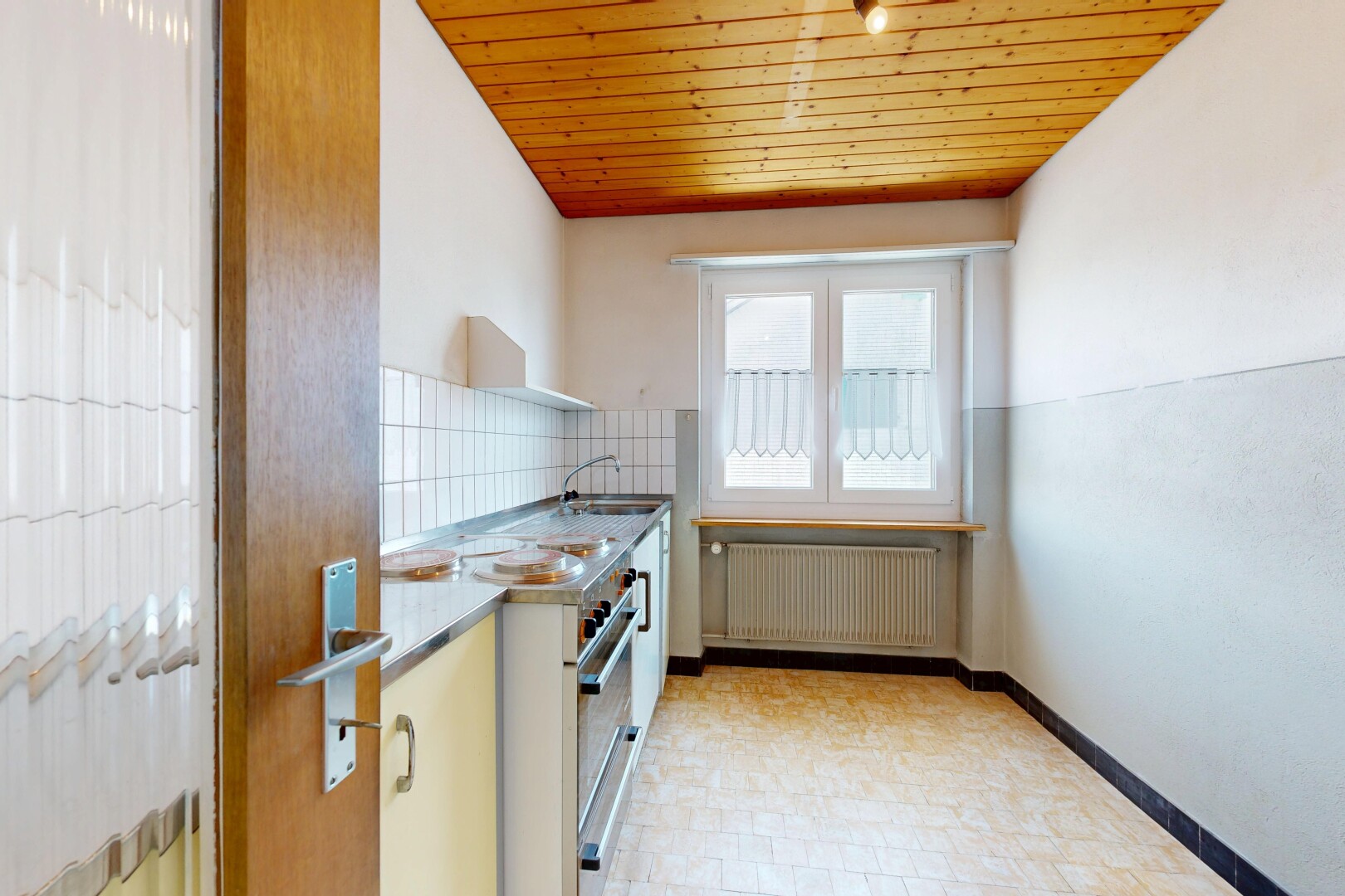 kitchen featuring wood ceiling, radiator, and backsplash