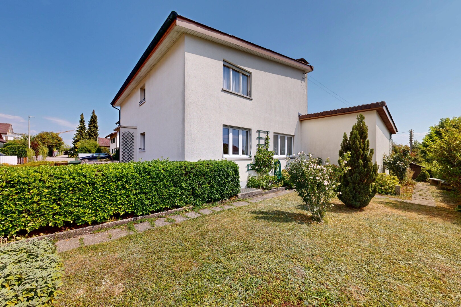 outdoor house with a yard and stucco siding