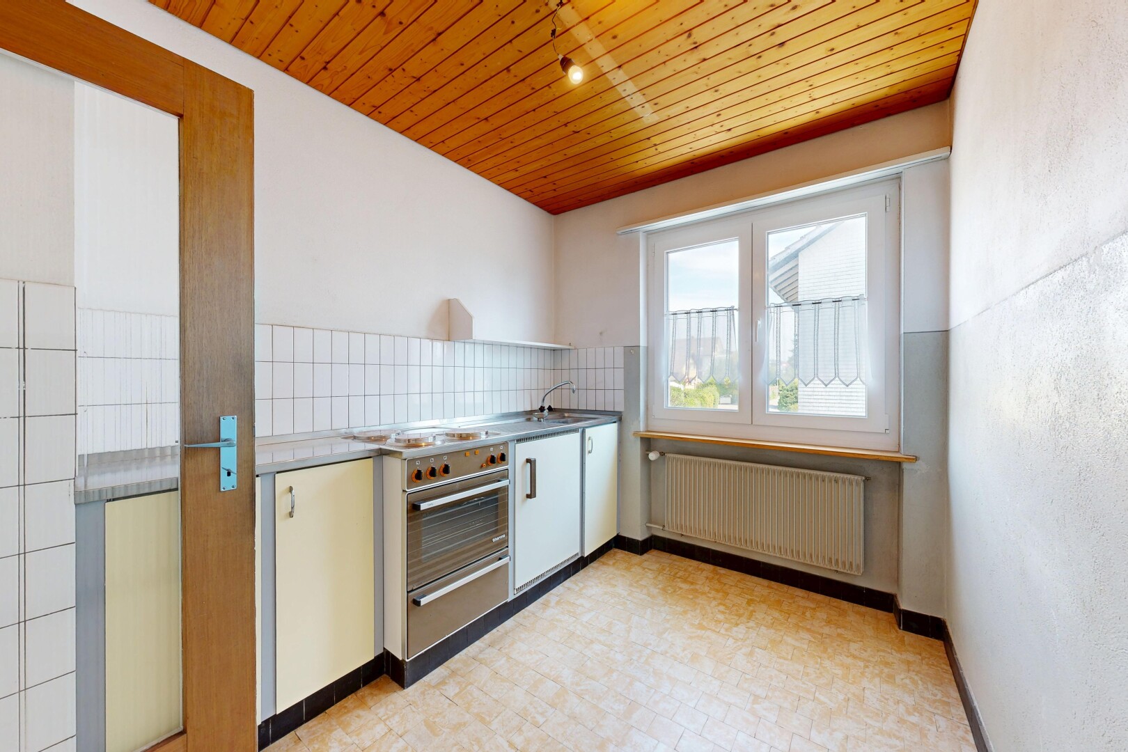 kitchen with wooden ceiling, radiator, decorative backsplash, a warming drawer, and light floors