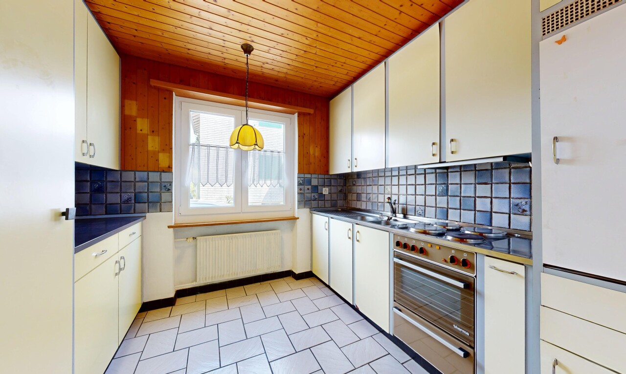 kitchen with decorative backsplash, dark countertops, radiator, wood ceiling, and white cabinets