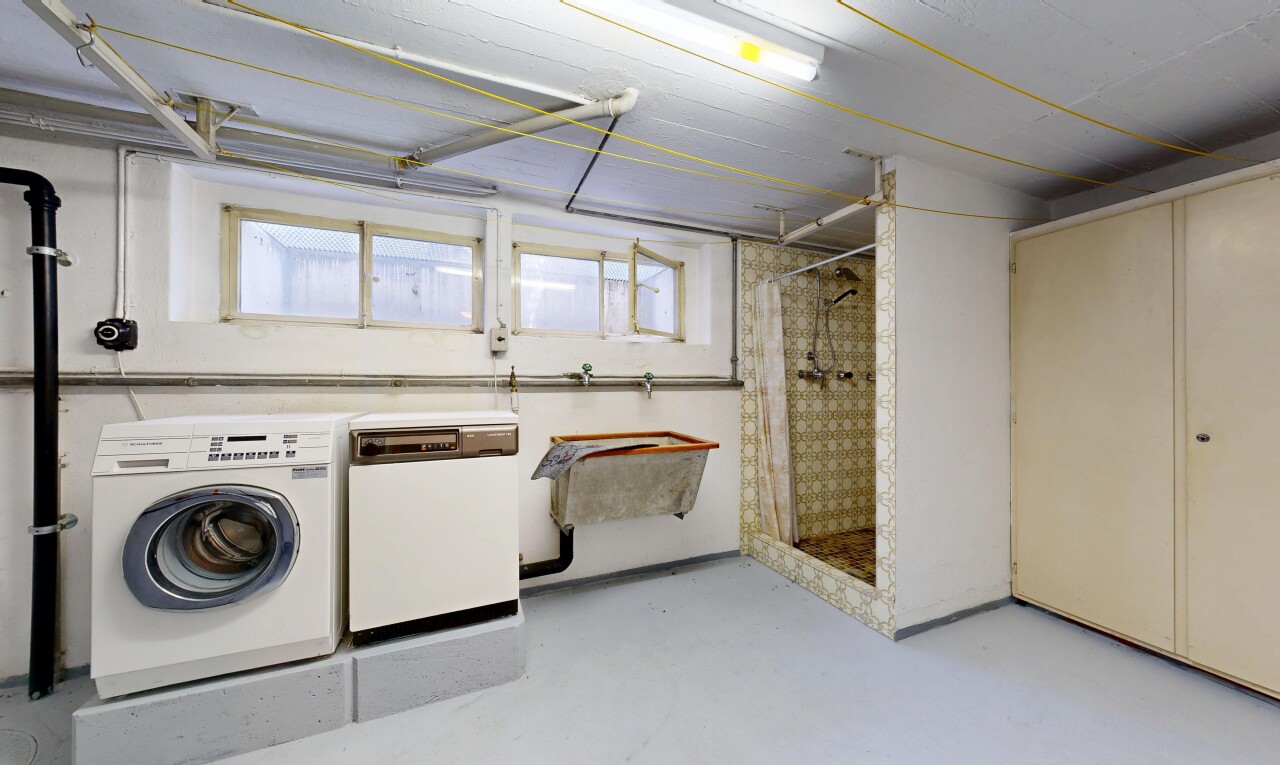 laundry area with washer and clothes dryer and concrete flooring
