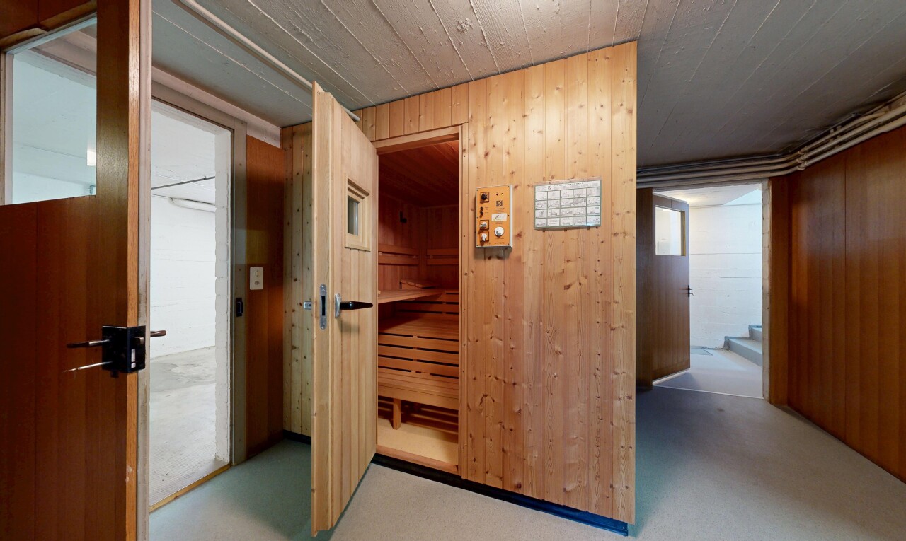 hallway with wood walls and a relaxing sauna