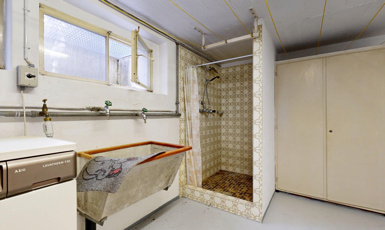 full bath featuring a shower stall and concrete floors