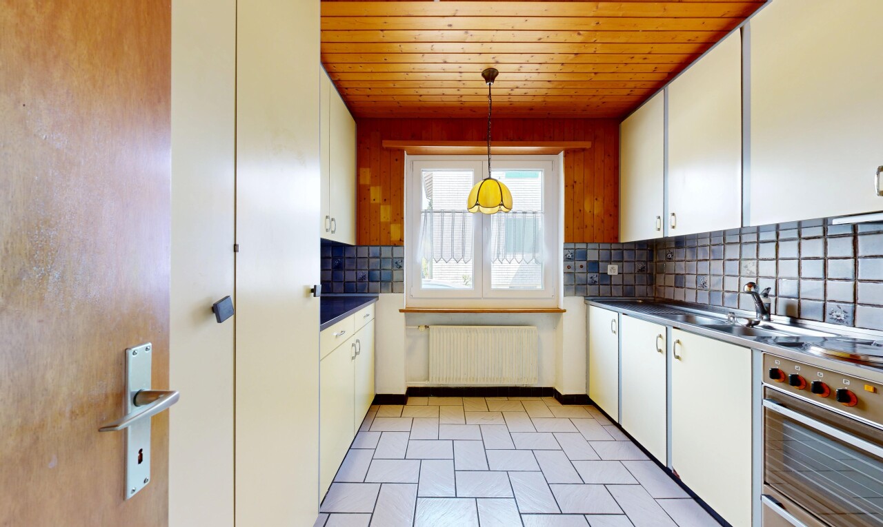 kitchen featuring backsplash, white cabinetry, dark countertops, wood ceiling, and radiator
