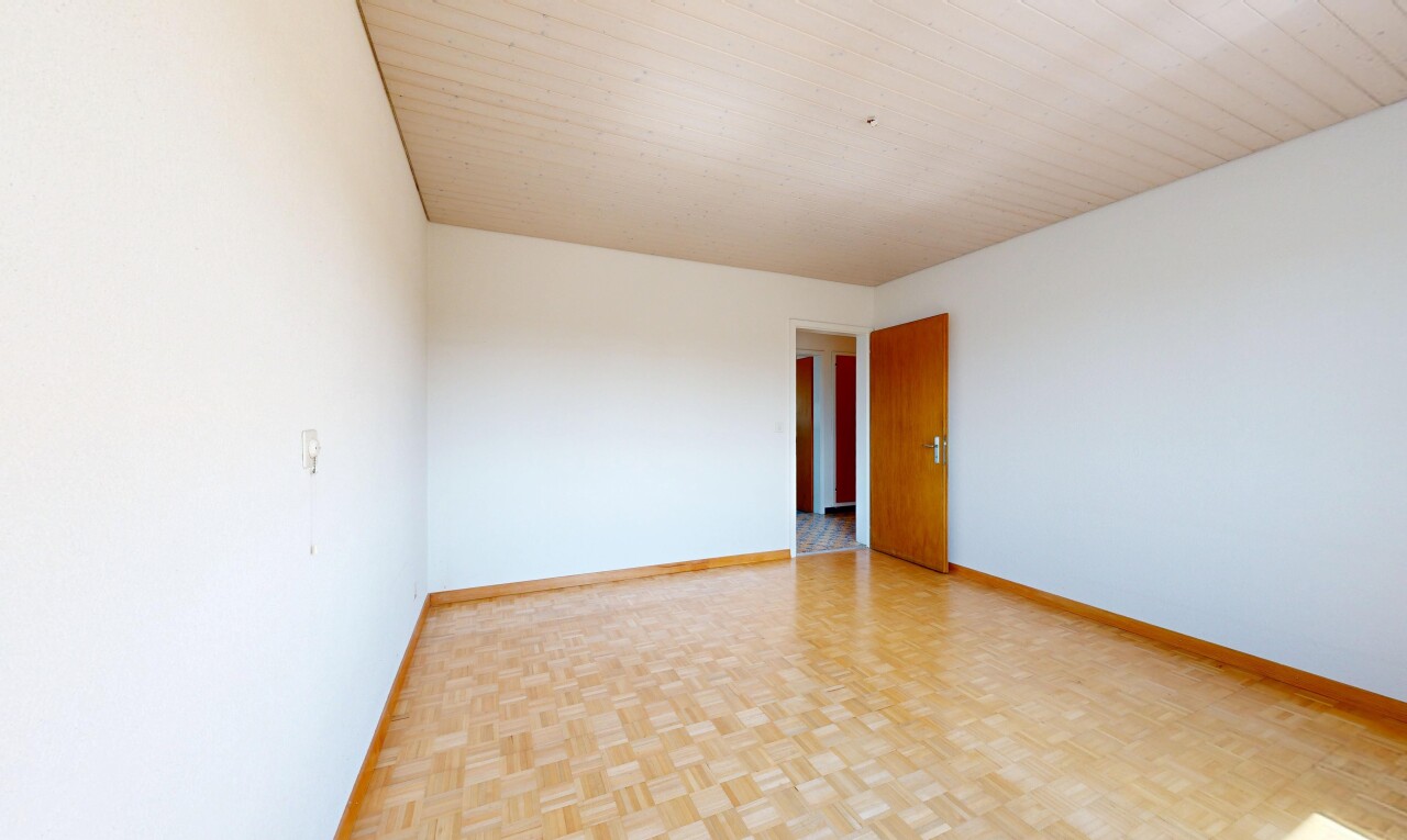 unfurnished room with parquet flooring and baseboards
