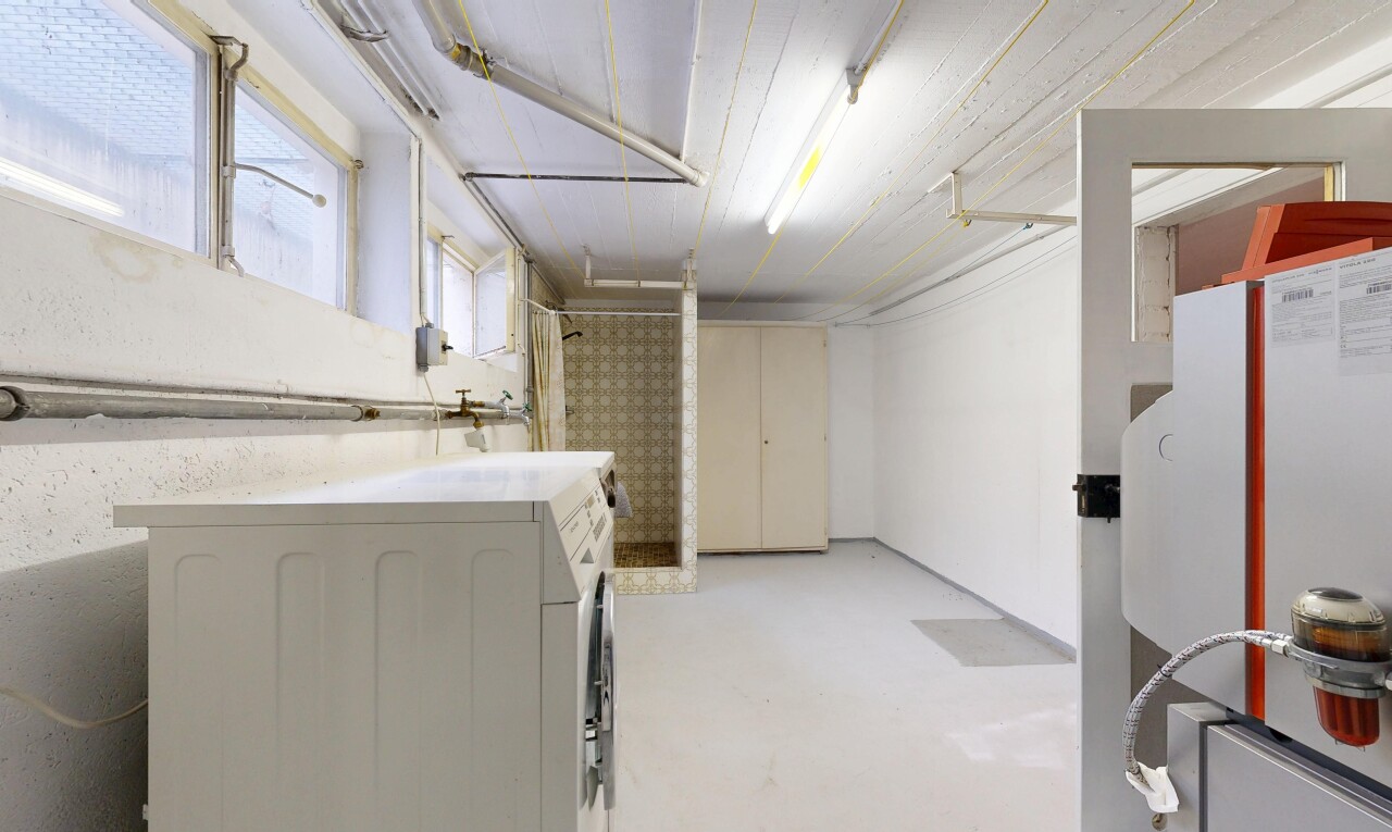 laundry area featuring washer / clothes dryer and concrete floors