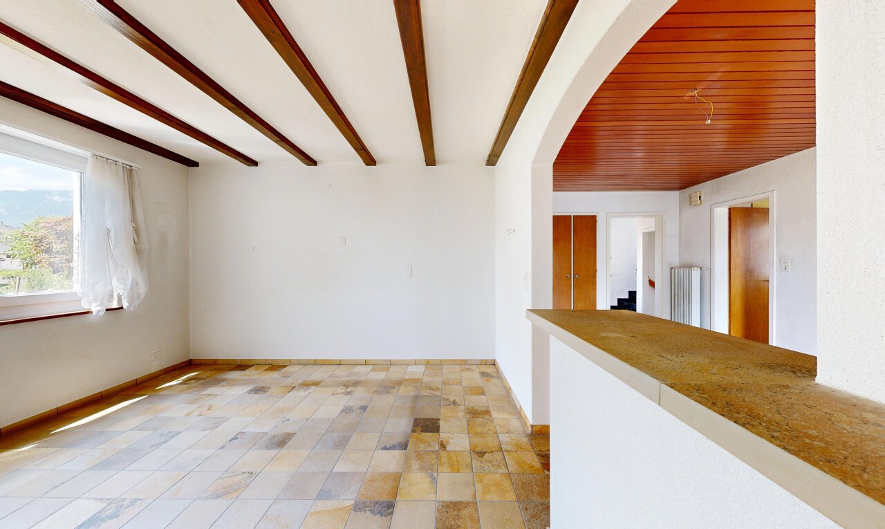unfurnished room with beamed ceiling and baseboards