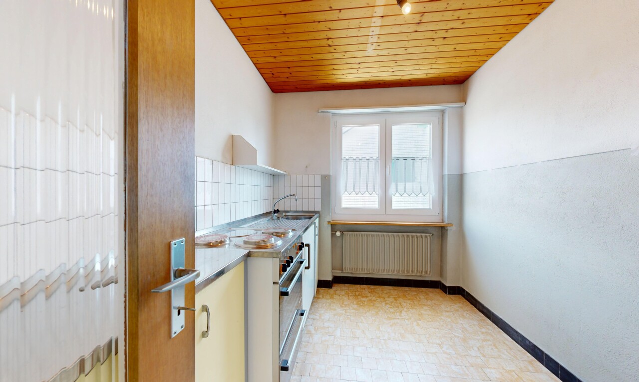 kitchen featuring wood ceiling, radiator, and backsplash