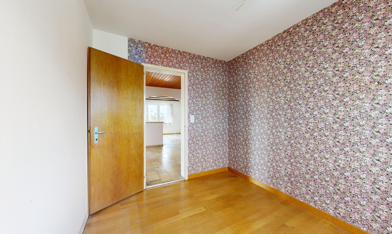 spare room featuring wallpapered walls and light wood-style flooring