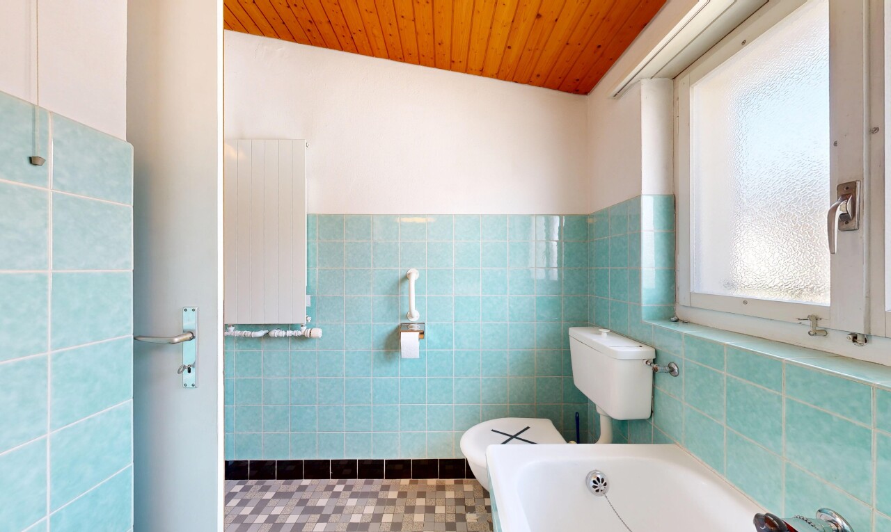 full bath with radiator heating unit, a bath, tile walls, wooden ceiling, and wainscoting