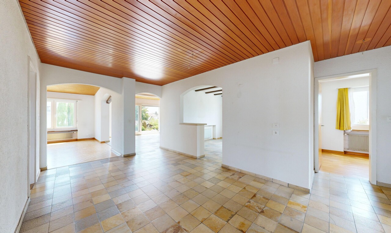unfurnished room with wood ceiling, radiator heating unit, and arched walkways