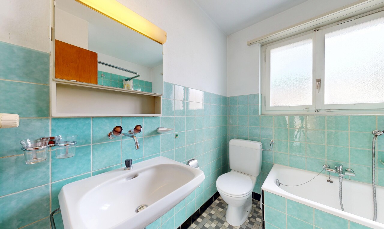 bathroom featuring a bath, tile walls, and tile patterned flooring
