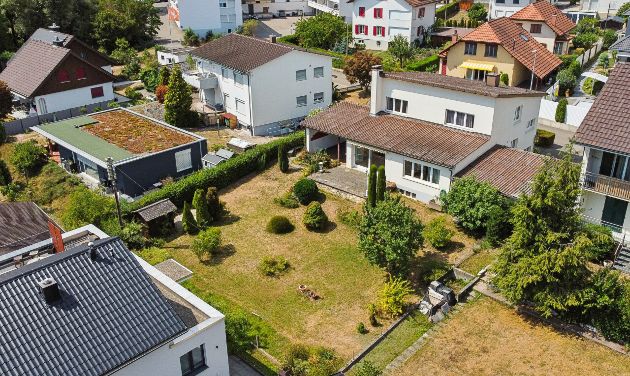 outdoor house featuring a residential view and a tiled roof