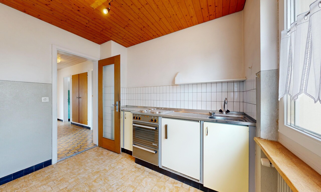 kitchen with wooden ceiling, decorative backsplash, white cabinetry, and light flooring