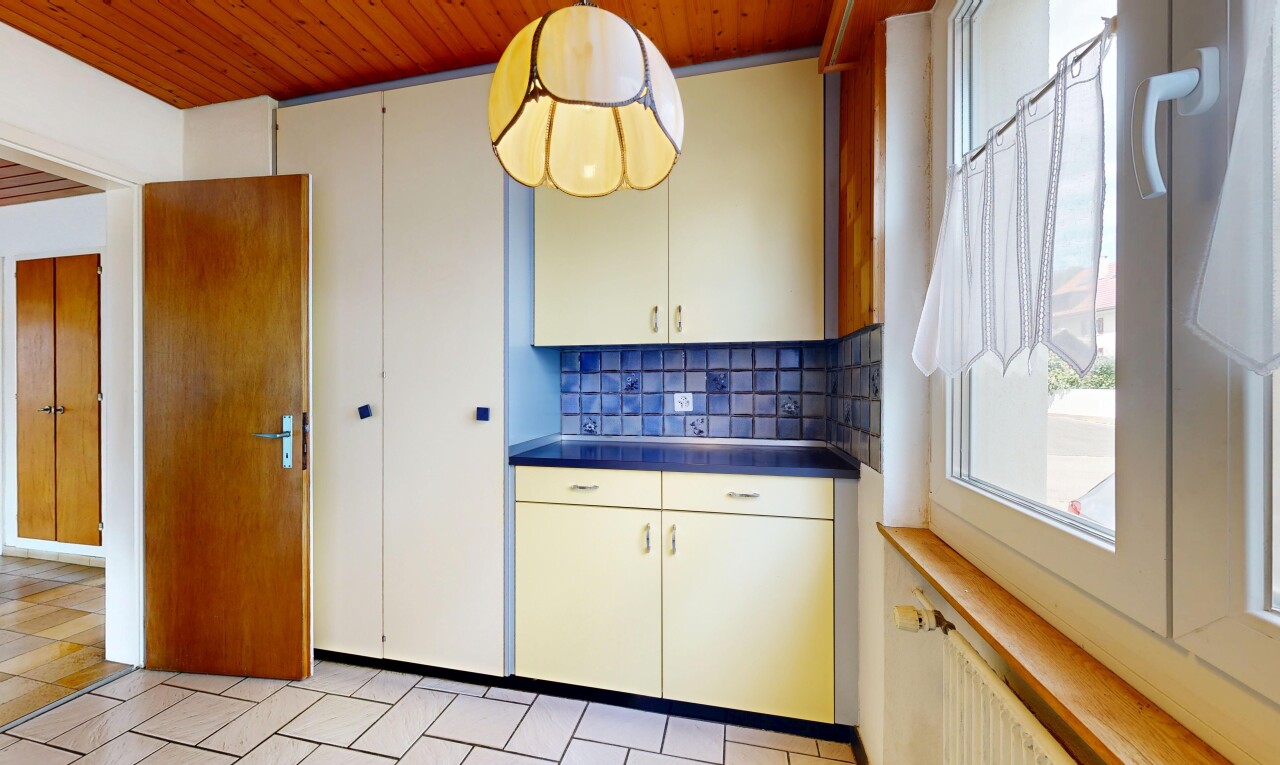 kitchen featuring backsplash, wood ceiling, dark countertops, white cabinets, and radiator heating unit