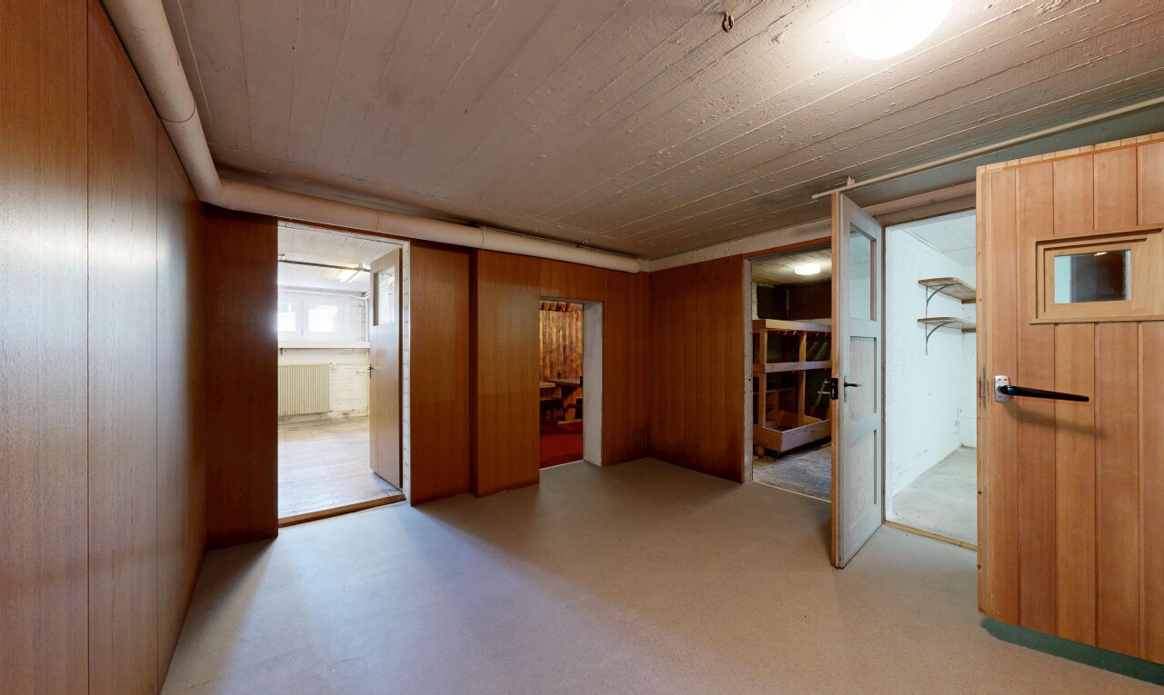 unfurnished room featuring wood walls