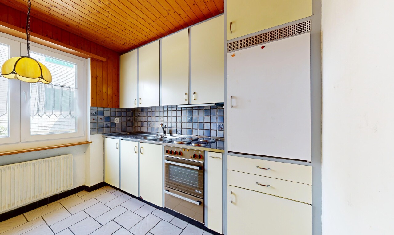 kitchen featuring backsplash, radiator heating unit, a warming drawer, wooden ceiling, and dark countertops