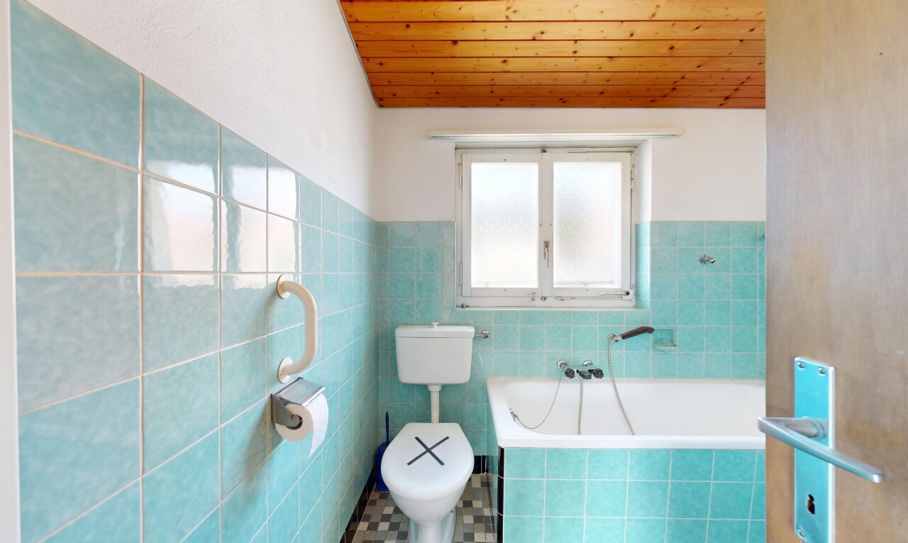 full bath with a garden tub, a vaulted wooden ceiling, tile walls, and a wainscoted wall