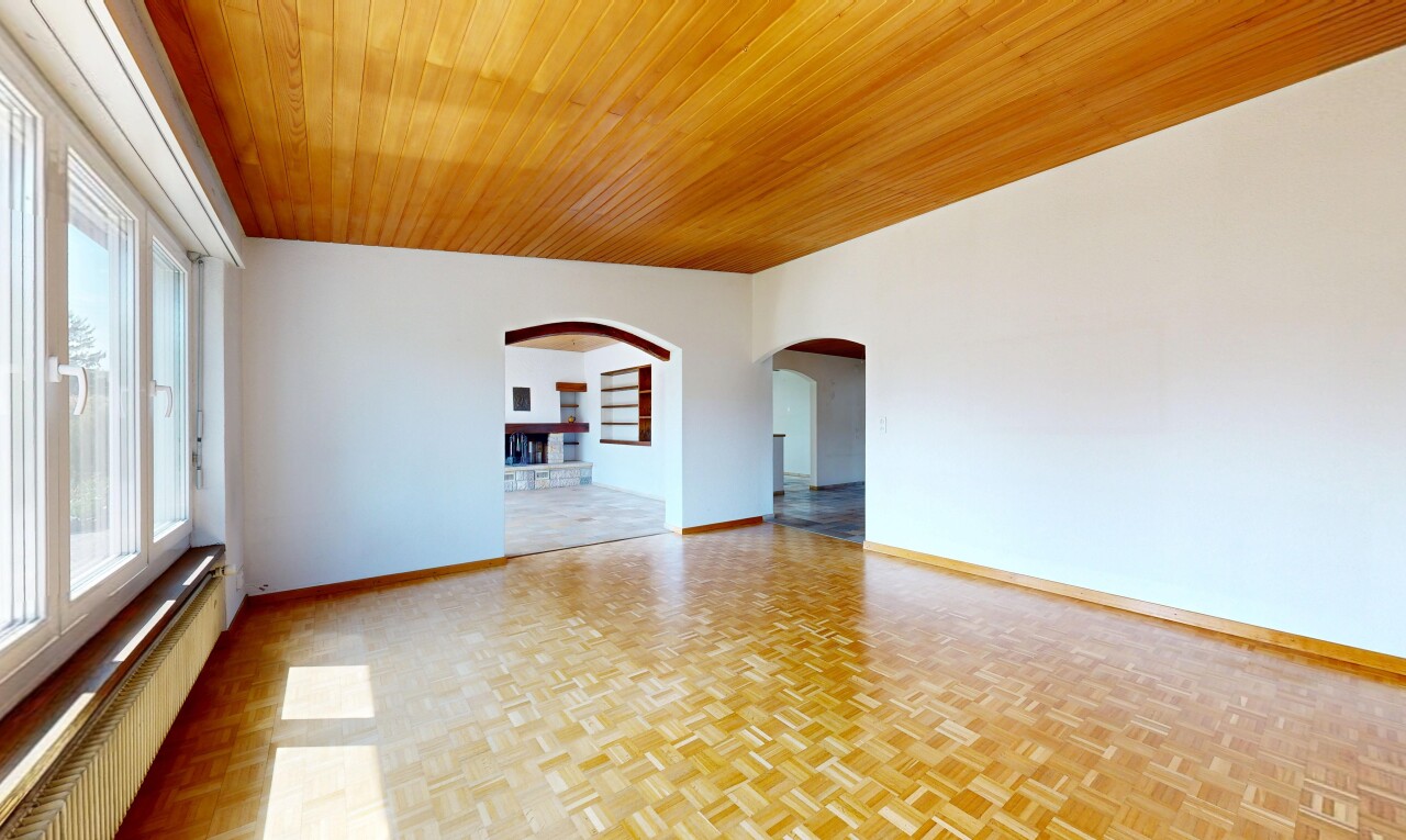 spare room featuring built in shelves, radiator heating unit, wood ceiling, arched walkways, and parquet floors