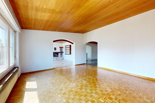 spare room featuring built in shelves, radiator heating unit, wood ceiling, arched walkways, and parquet floors