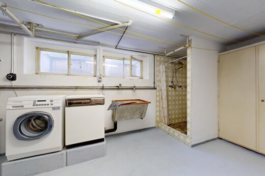 laundry area with washer and clothes dryer and concrete flooring