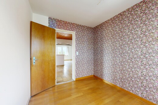 spare room featuring wallpapered walls and light wood-style flooring