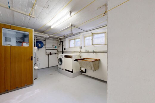 laundry area with concrete floors