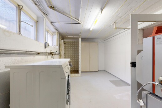 laundry area featuring washer / clothes dryer and concrete floors